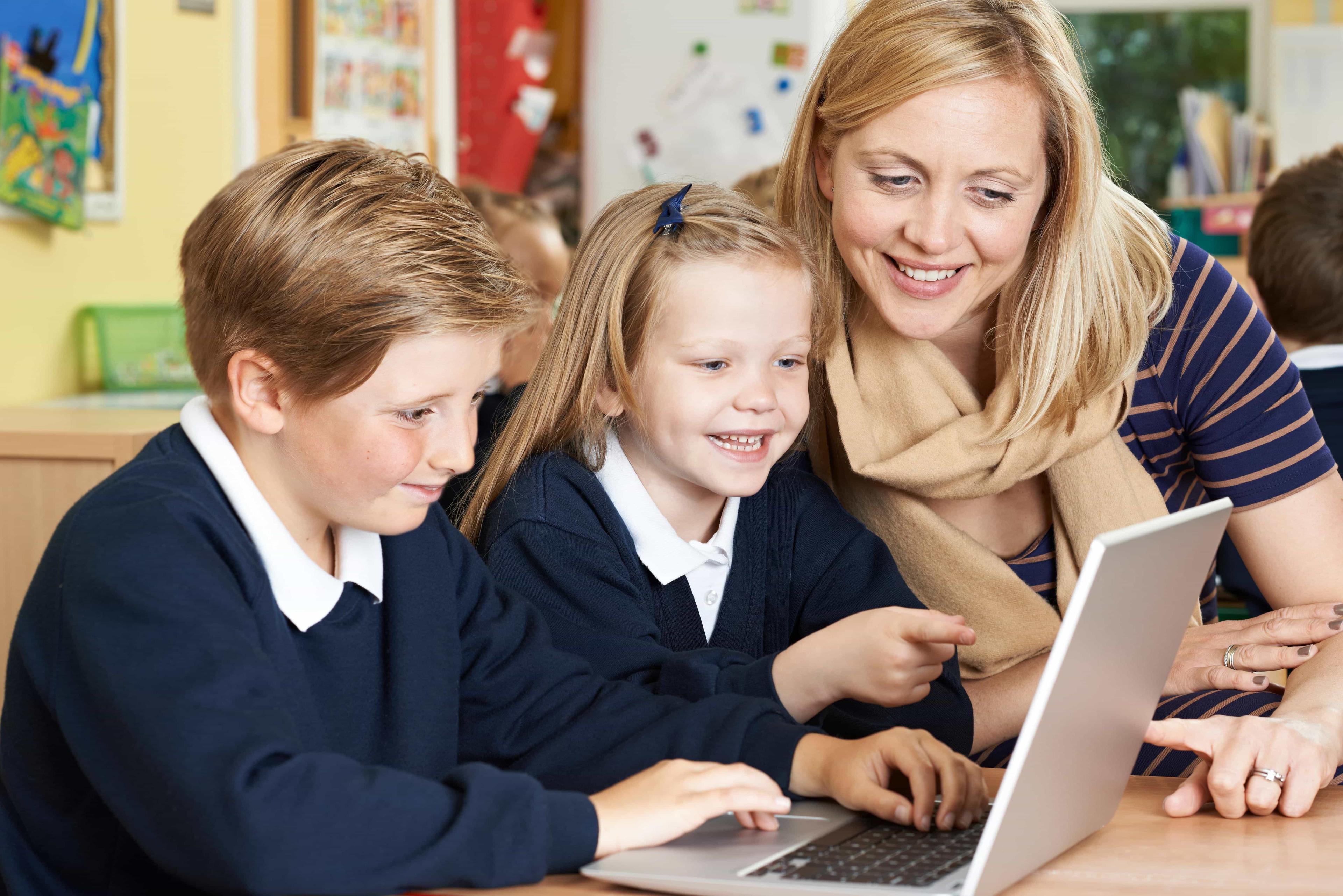 A tutor working with preps school students, helping them to practice questions for their common entrance exams. 