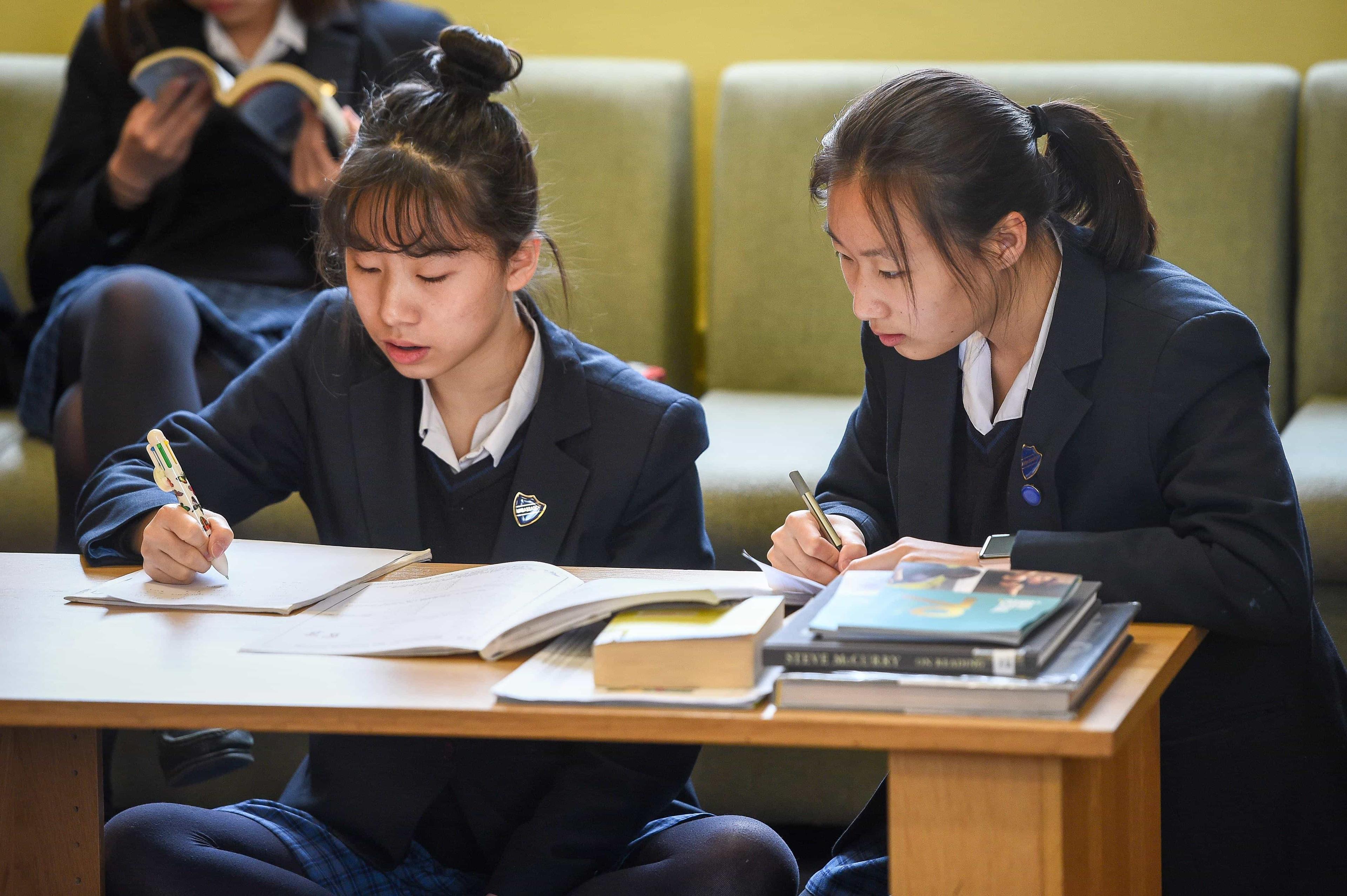 Two female students discussing their strategies for debating and mooting at their independent school