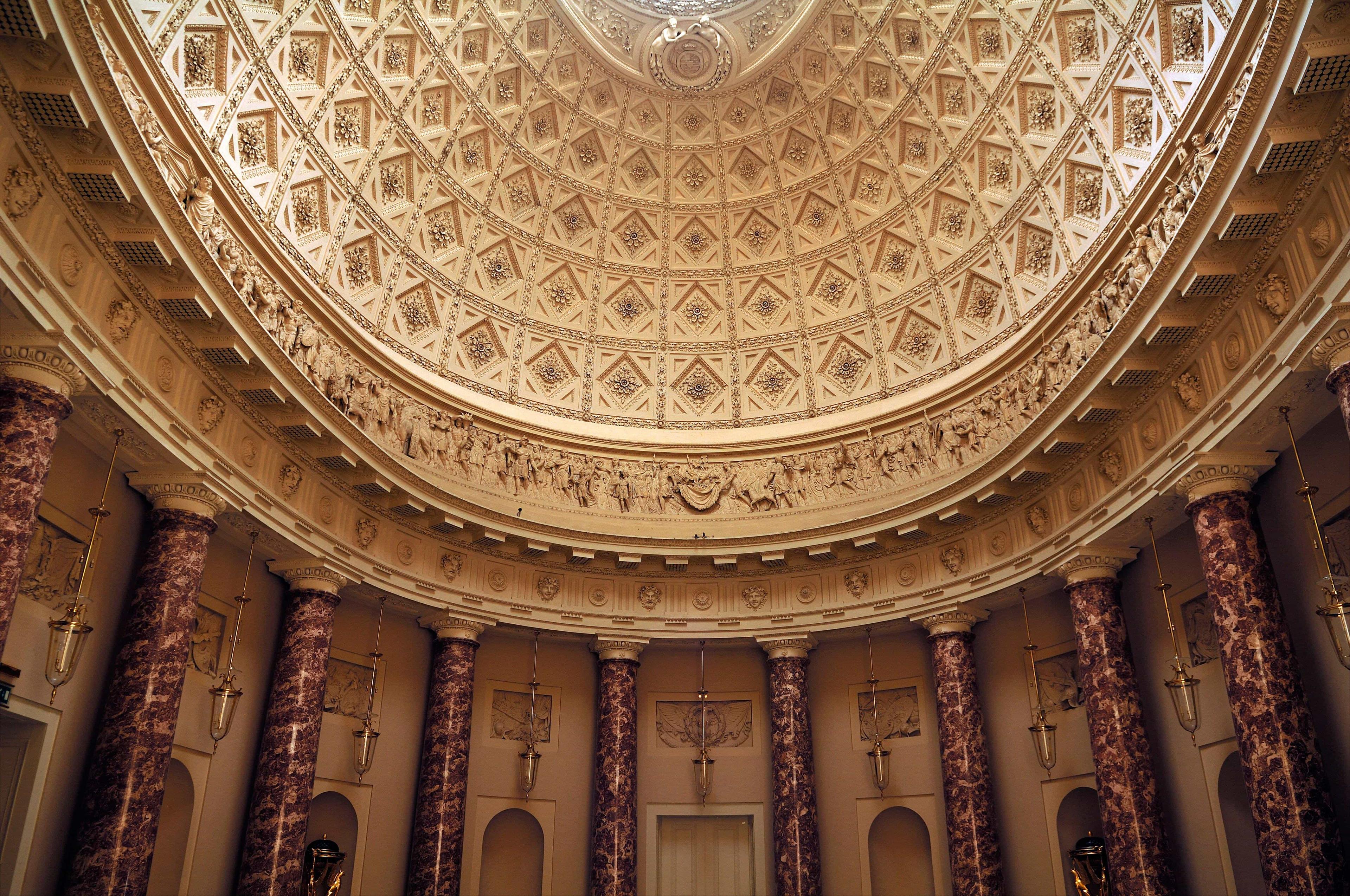 Inside the old UK university, a stunning gold-coloured ceiling creates a captivating atmosphere.