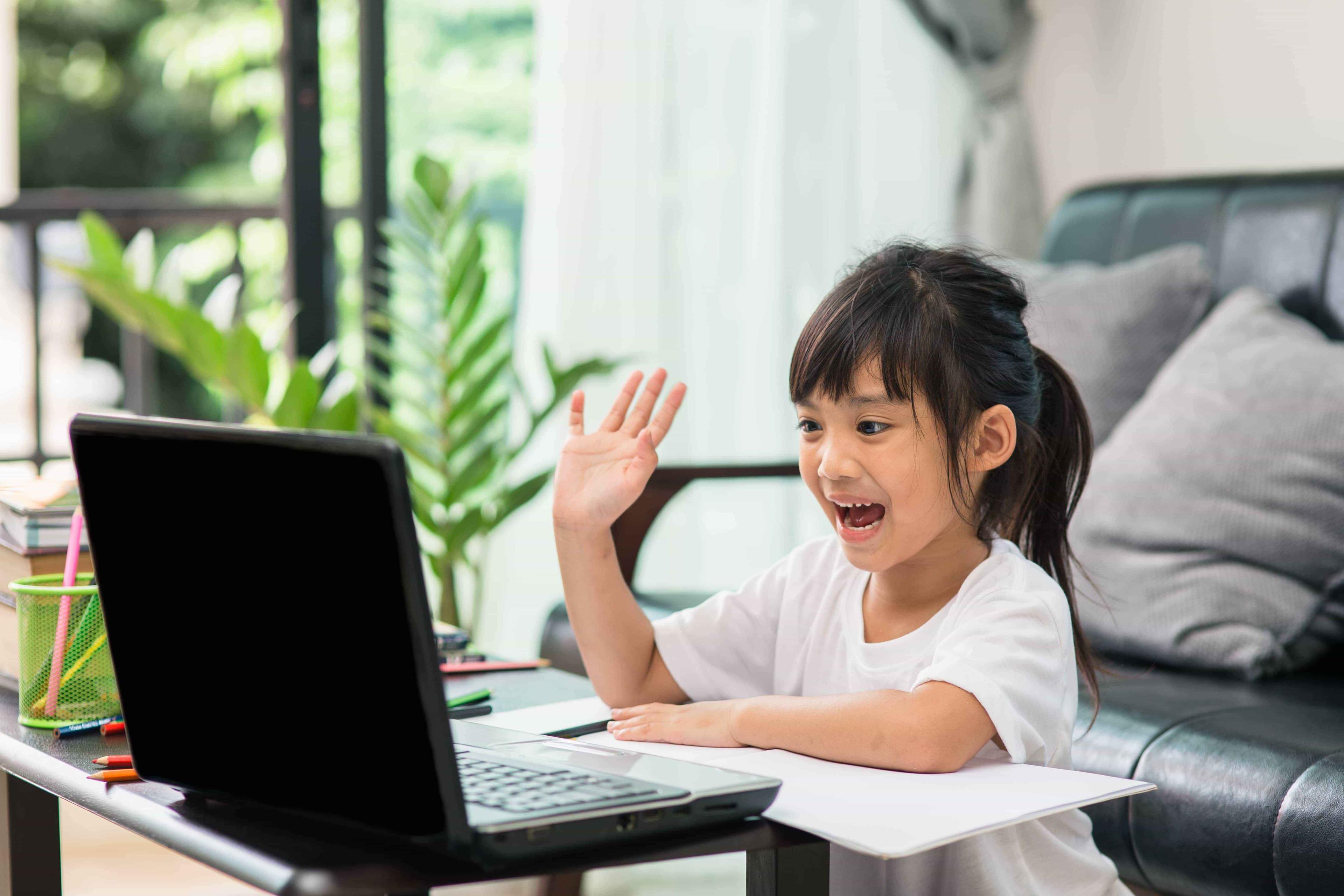 A Path Edcuation stduent waves at their online maths tutor during a one-to-one lesson.