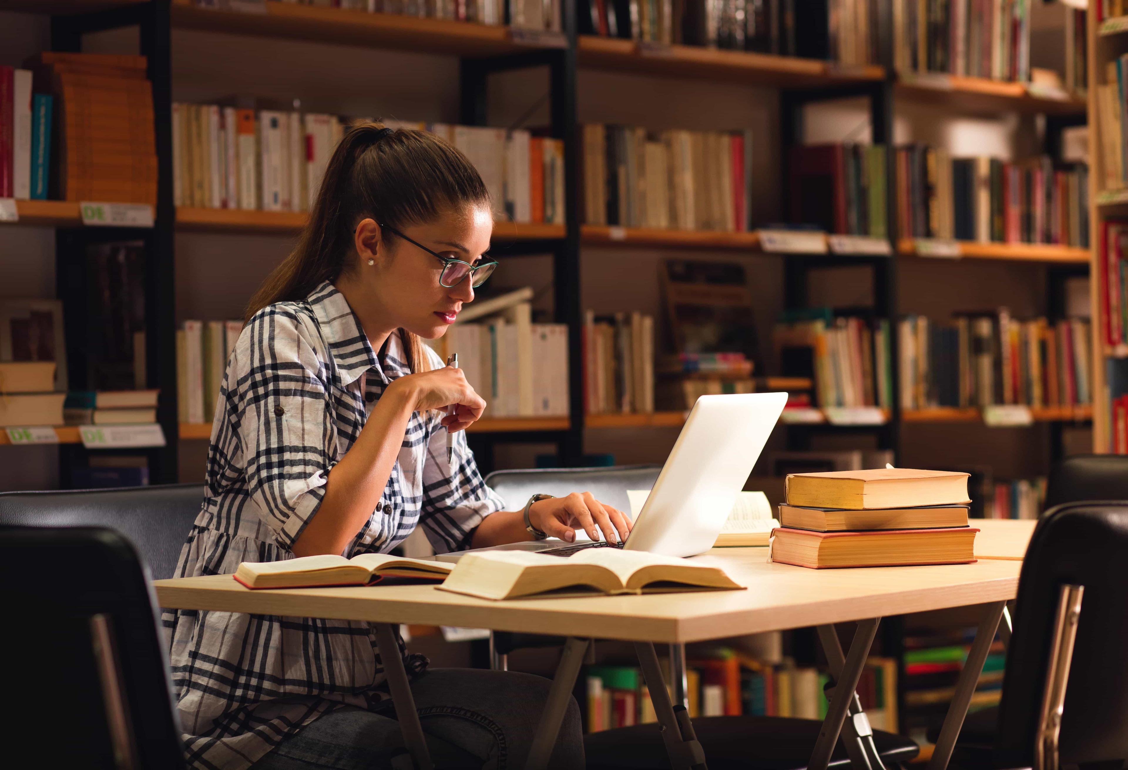 A female student sits in the library, preparing for he university admission test.